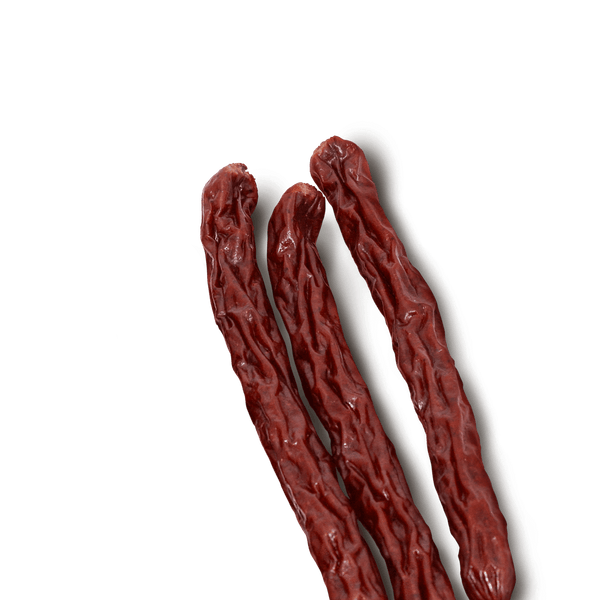 Three beef jerky sticks on a transparent background. 