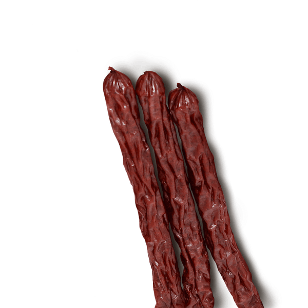Three beef sticks on a transparent background. 