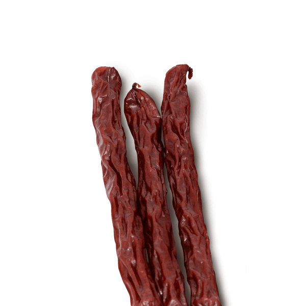 Three beef sticks on a transparent background. 