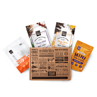 Branded box with assortment of beef jerky bags in it while against a transparent background. 