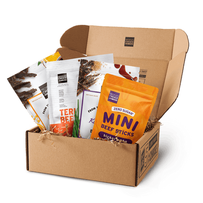 Branded box with assortment of beef jerky bags in it while against a transparent background. 