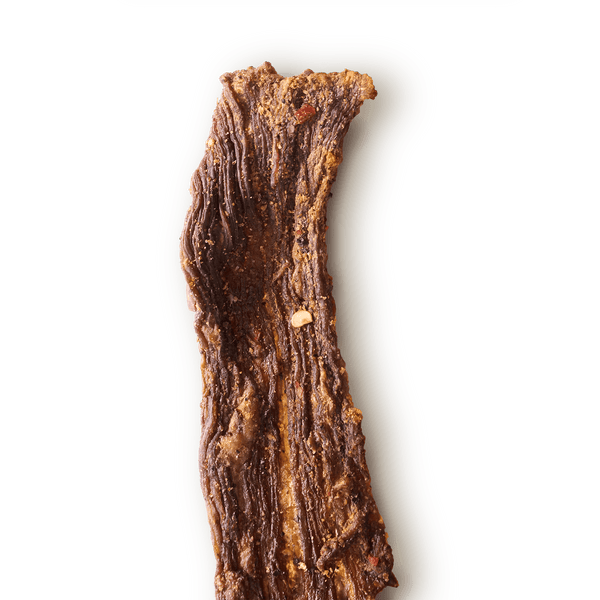 Piece of Limon Con Chile Beef Jerky on a white background. 