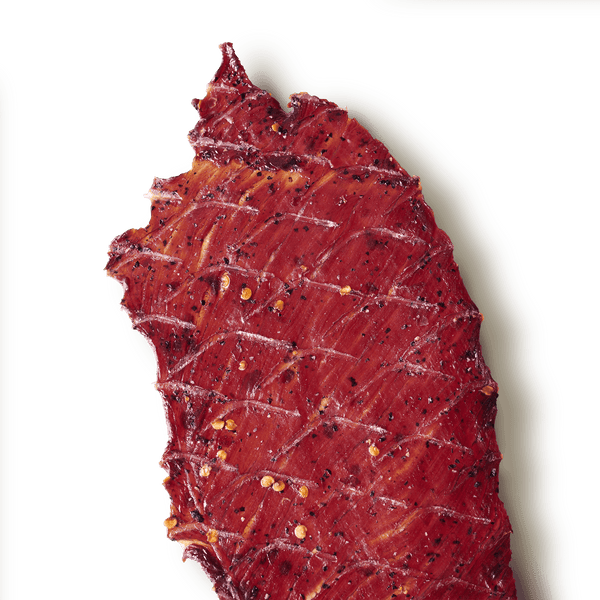 Slab of beef jerky on a transparent background. 