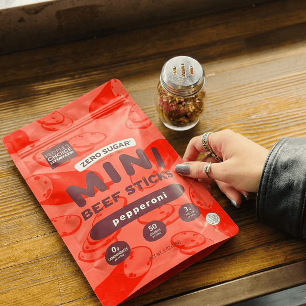 Red package of Mini Beef Sticks with pepperoni flavor on a wooden surface