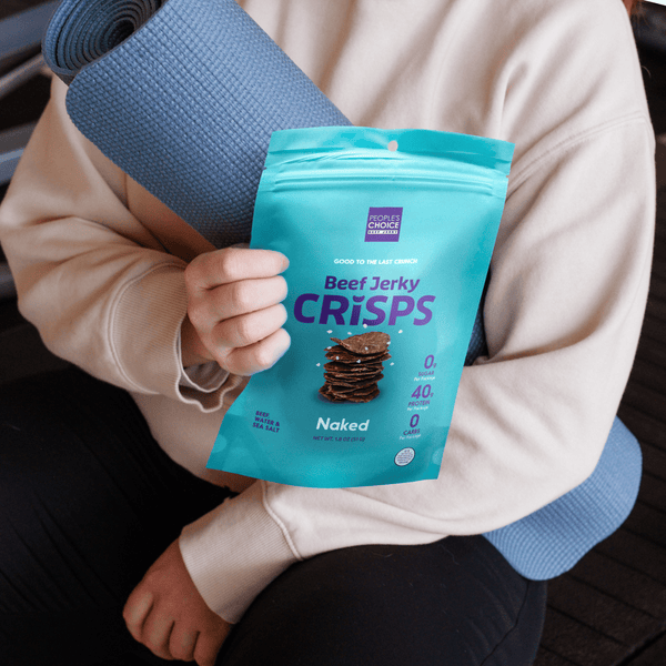 Woman holding a bag of beef jerky crisps. 