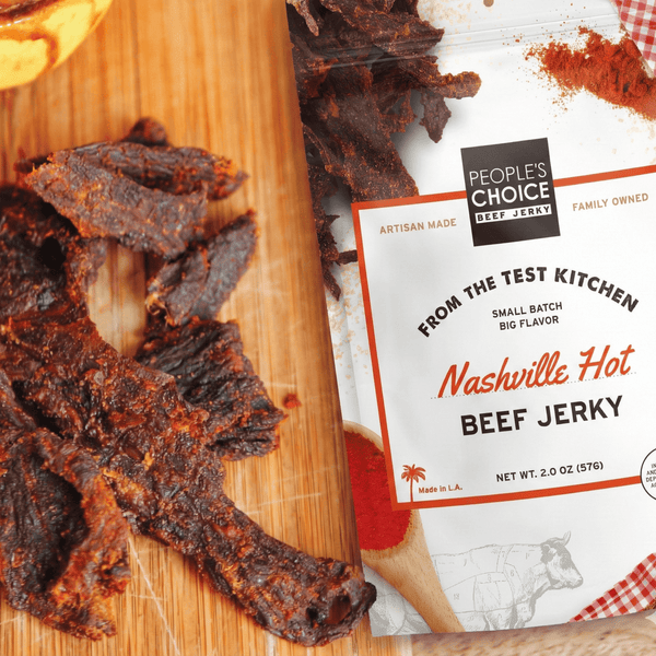 People's Choice Nashville Hot Beef Jerky on a wooden cutting board with packaging.