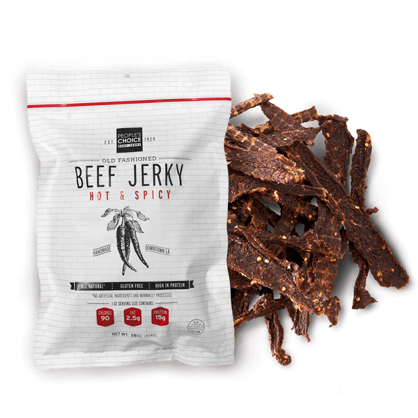 Beef jerky package with hot and spicy flavor next to some dried beef strips on a white background