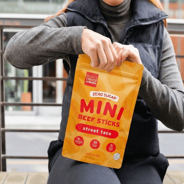 Person holding a package of Zero Sugar Mini Beef Sticks Street Taco flavor