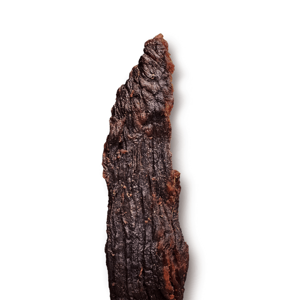 Close-up of a textured, beef jerky piece on a transparent background