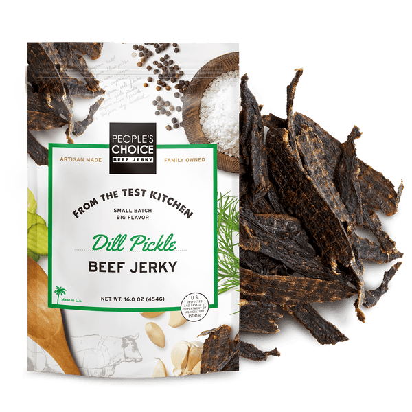 Dill pickle beef jerky packaging with jerky pieces on a white background