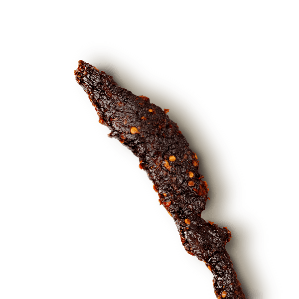 Close-up of a textured, beef jerky piece on a transparent background